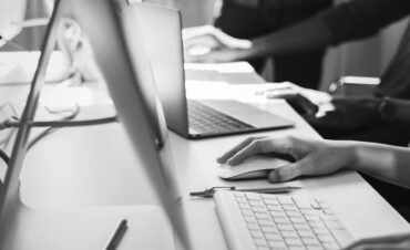 Close up of people's hands working on computers